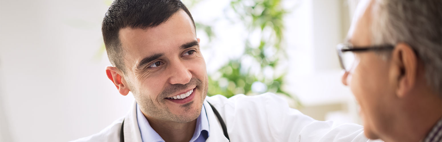 male doctor talking with elderly patient